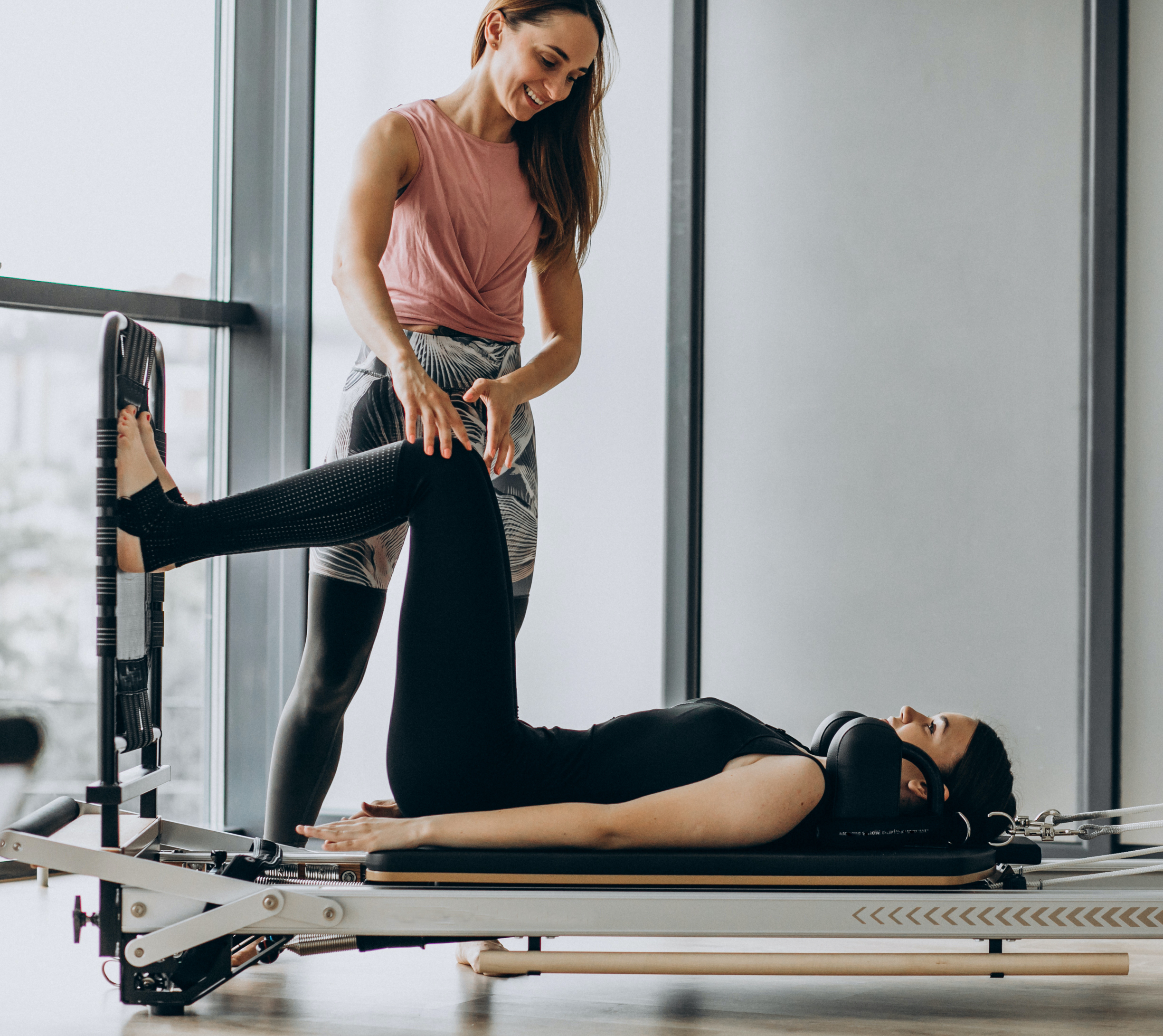 Woman training pilates on the reformer